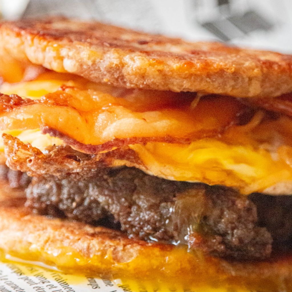 Homemade McGriddle with sausage, egg, and cheese on a plate, ready in under 30 minutes.