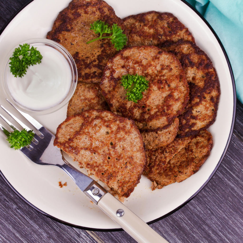 Cooking sausage patties in a skillet until browned and fully cooked.